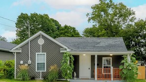 A single-story house with a grey shingled roof, a front porch with a wooden railing, and a mailbox. - Pet-Friendly Bluegrass Retreat w/ Fenced Yard (Georgetown)