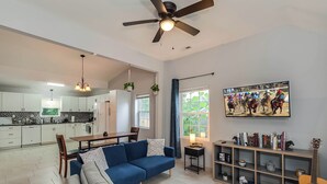 A spacious living area with a sofa, a dining table, and a kitchen in the background. - Pet-Friendly Bluegrass Retreat w/ Fenced Yard (Georgetown)