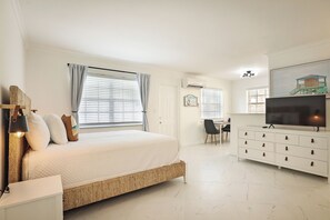 A bedroom with a bed, a desk, a television, and a dresser. - La Mer Suites (Lauderdale-by-the-Sea)
