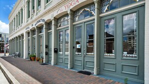 A building with a sign that reads "The Yoga Hooked on Acupuncture." - Stylish Downtown Loft, Walk to The Strand (Galveston)