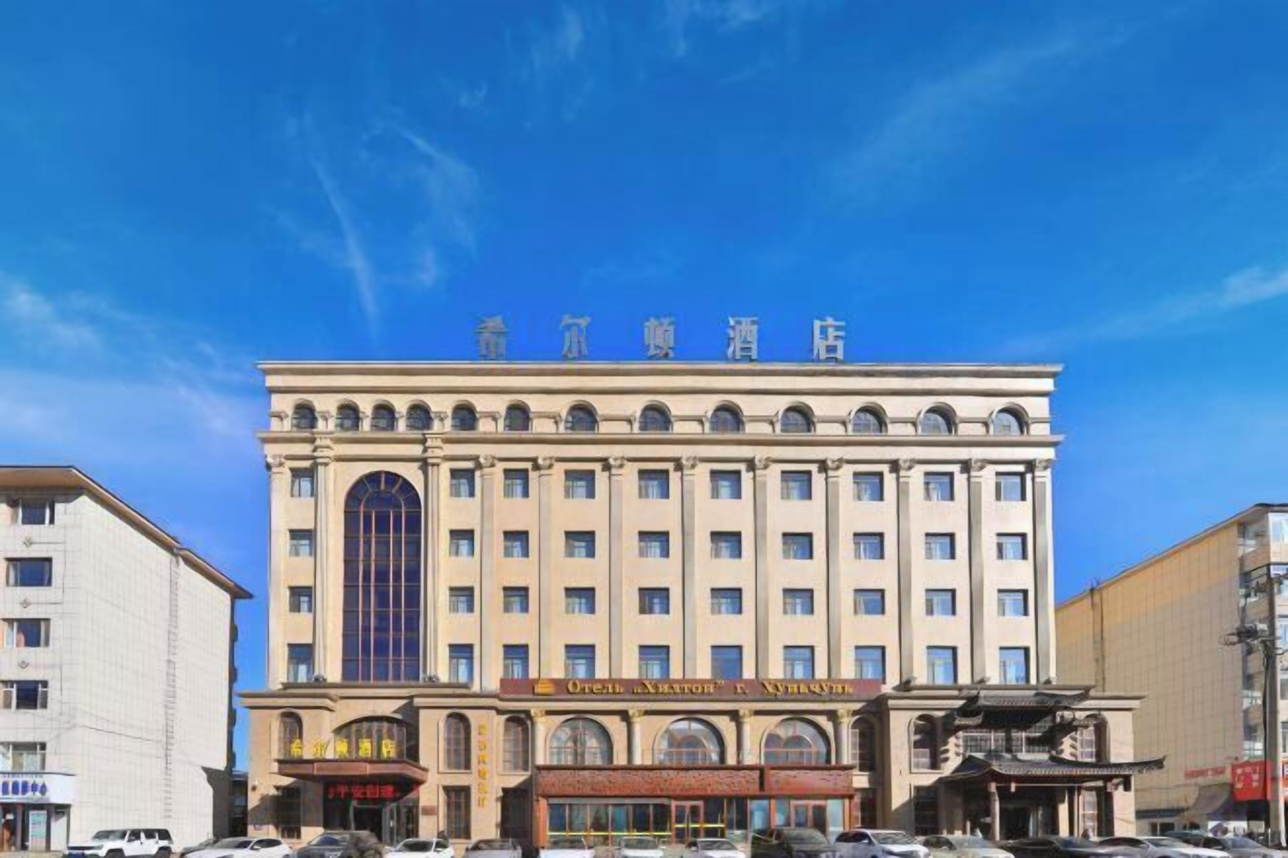 A multi-story hotel with a prominent entrance and signage.