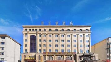 A multi-story hotel with a prominent entrance and signage.