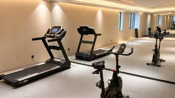 A gym with treadmills, an elliptical, and stationary bikes.
