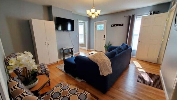 A compact living space with a sofa, a small table, and a decorative vase. - Single level 3 bedroom, fenced yard, central air (Auburn)