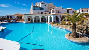 A large swimming pool with a white building in the background. - Limoneros by Interhome (Nerja)