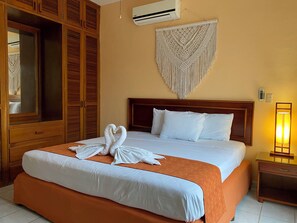 Relax in comfort with a large bed, wooden headboard, and stylish decor.