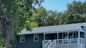 A house with a porch and a staircase leading to a deck. - Big Stone Lake, SD-Bayview area Lake Cabin (Big Stone City)
