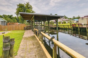 Enjoy a serene riverside retreat with a dock and shaded seating area.