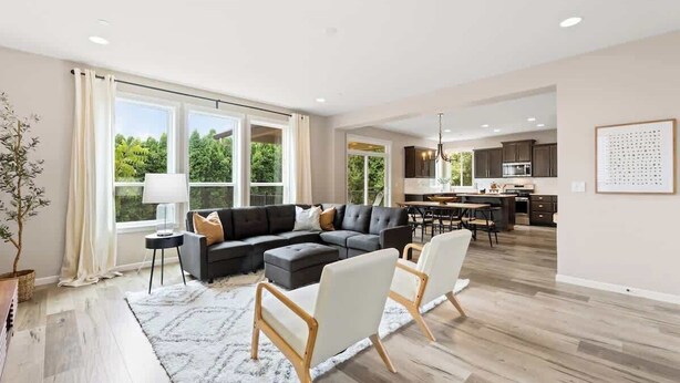A spacious living room with a sectional sofa, a dining area, and a kitchen in the background. - 5 Bedroom Home w/Guest Suite & Private Sauna (Camas)
