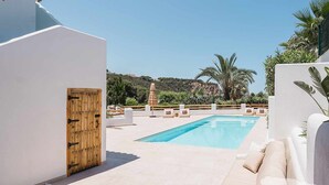 A poolside area with a white wall, a wooden door, and a lounge chair. - CostaBlancaDreams - The Jave in Javea (Javea)
