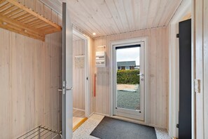 A wooden interior with a door leading outside, a small window, and a doorbell. - Fantastic view over Venø bay (Vinderup)