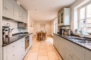 Enjoy cooking in this well-equipped kitchen with a central island and ample counter space.
