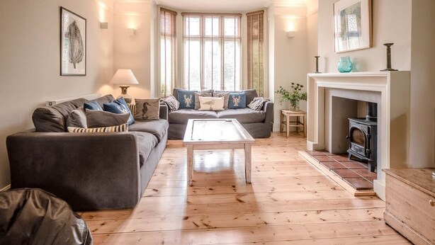 A cozy living room with a fireplace, a sofa set, and a coffee table. - 6 The Terrace, Walberswick (Walberswick)