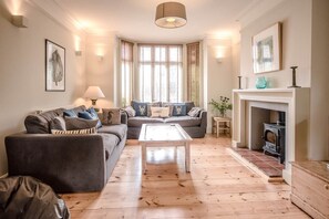 Relax in this inviting living room with a large sofa, coffee table, and fireplace.