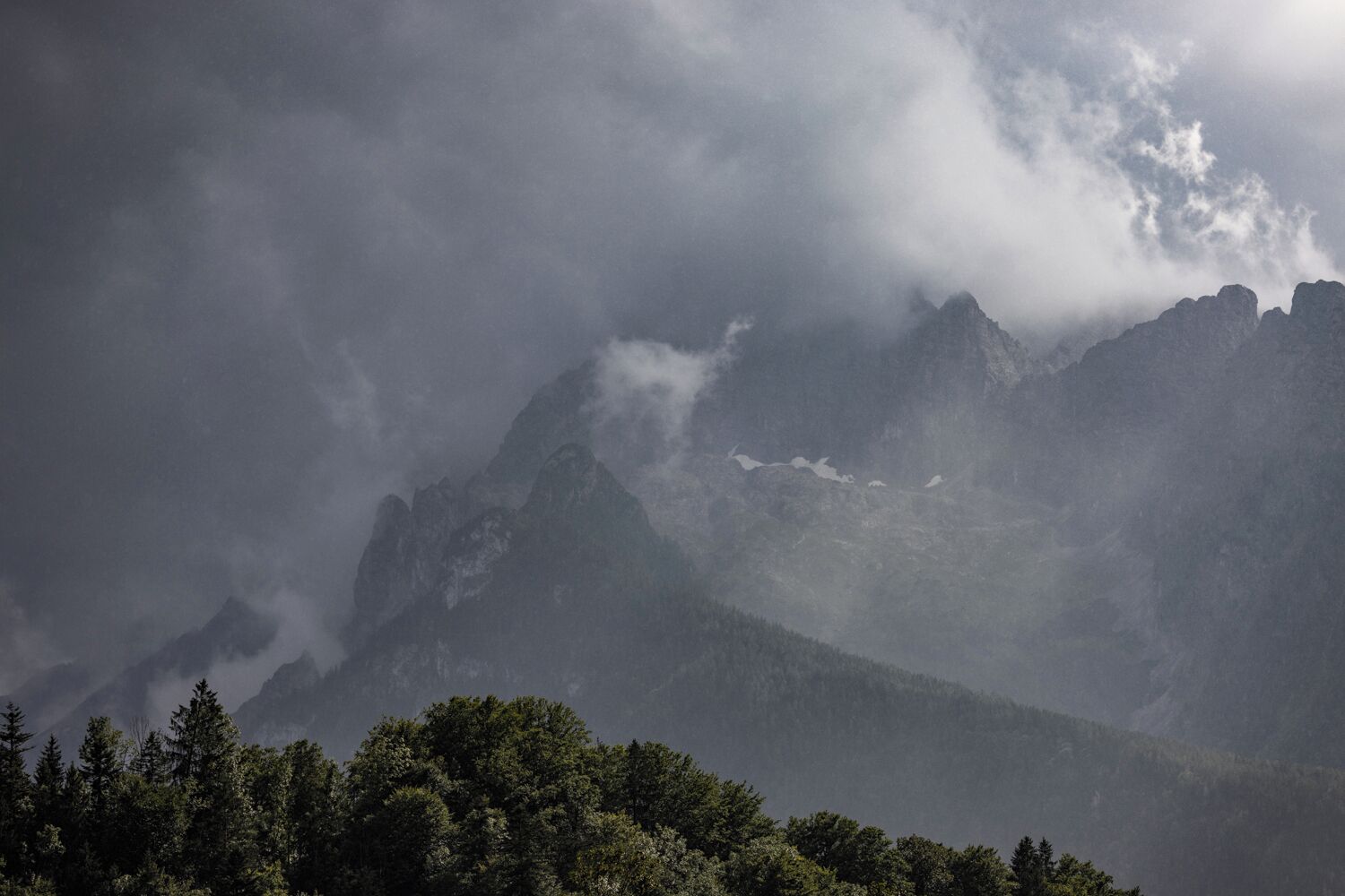 A mountainous landscape with dense forest at the base.