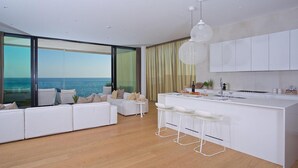 A modern kitchen with a large island, white cabinetry, and a view of the sea. - Stunning home in Novigrad with sauna (Novigrad)
