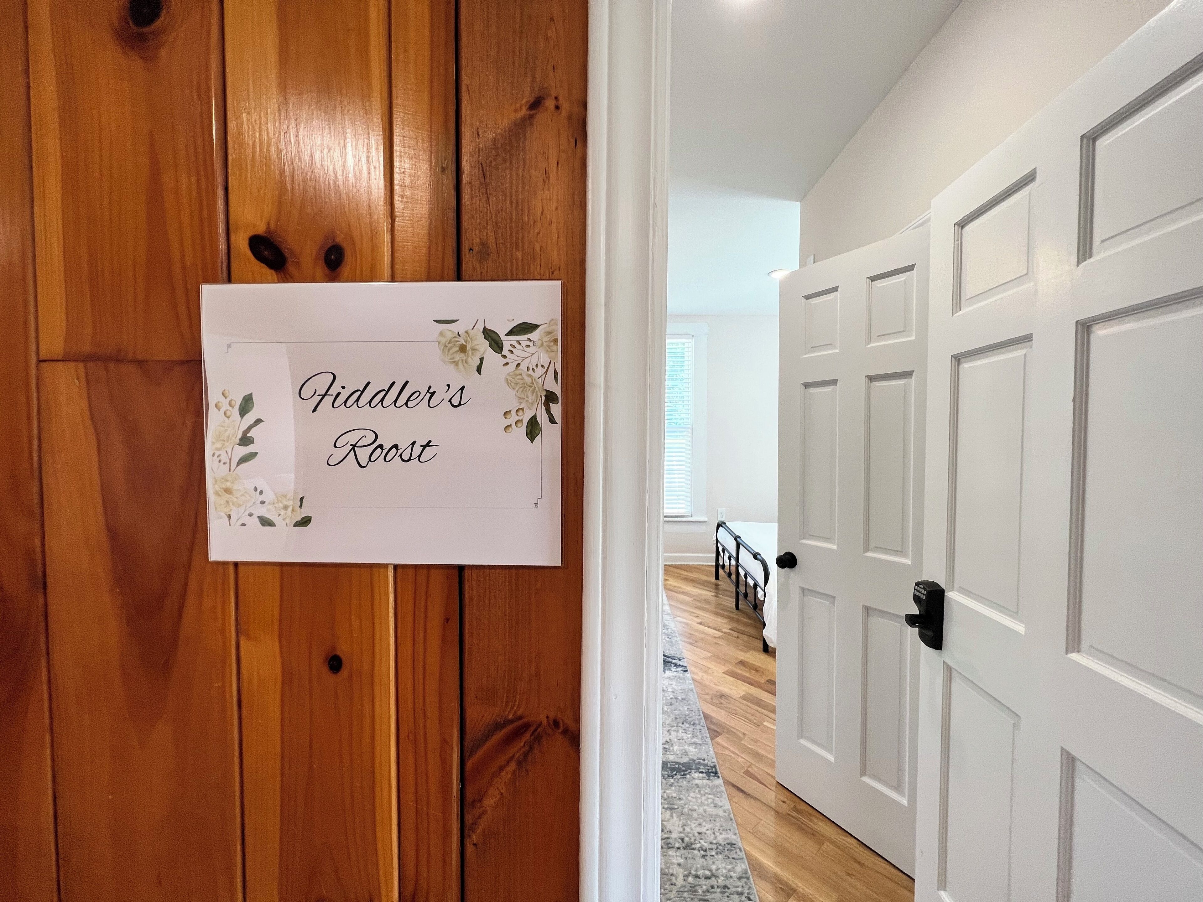 A hallway with a sign reading "Fiddler's Roast" on a wooden wall.