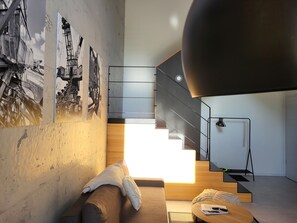 Ein modernes Interieur mit Treppe, Sofa und Couchtisch.