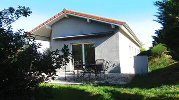 A house with a patio, a door, and a window.