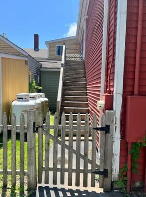 Stroll up the staircase to a residence with a secure entrance and a beautiful lawn.