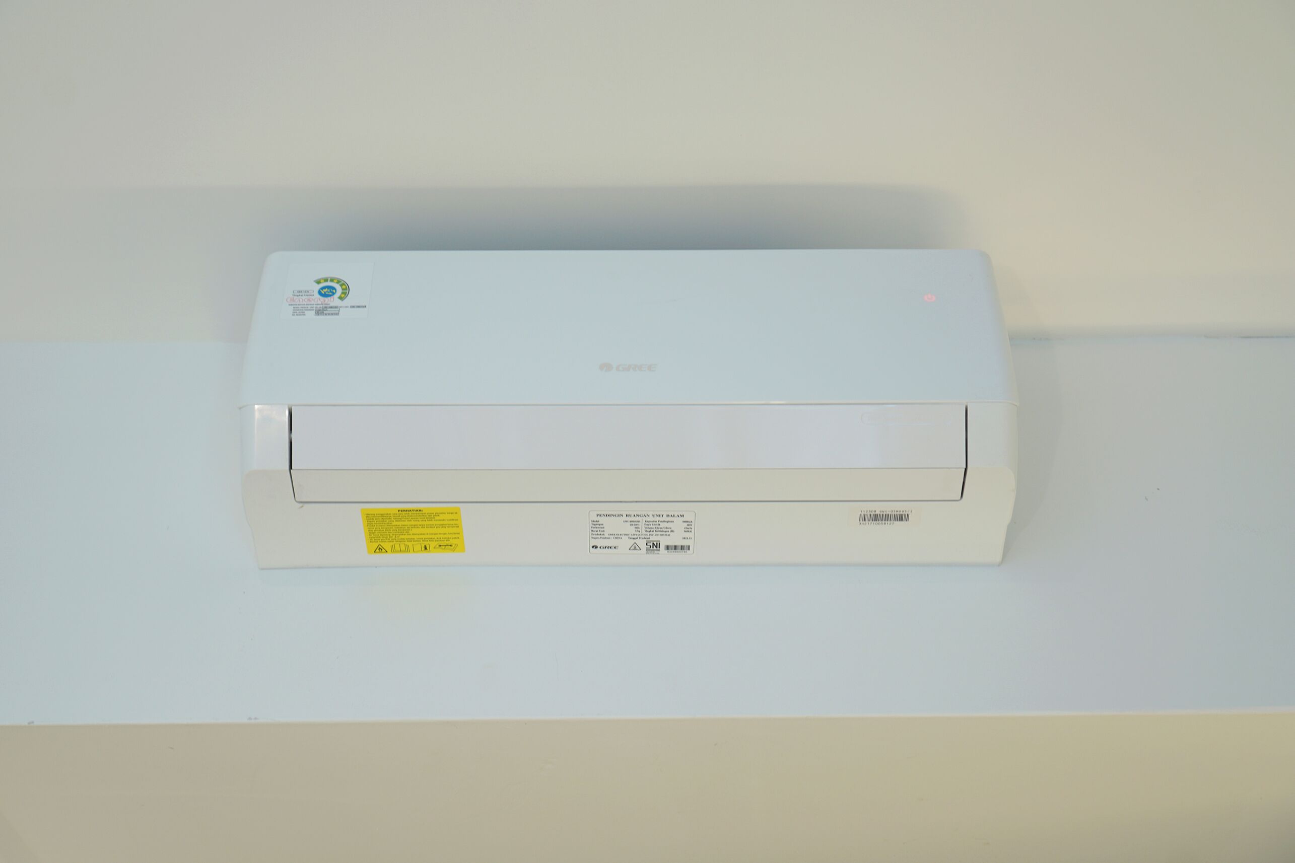 A white air conditioning unit mounted on a wall.
