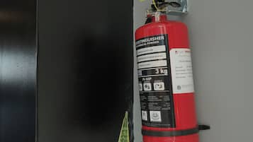 A red fire extinguisher mounted on a wall.