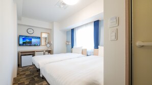 A hotel room with two beds, a desk with a computer, a clock, and a window with curtains. - Toyoko Inn Yokohama-Eki Nishi-Guchi (Yokohama)