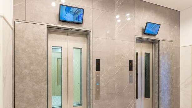 Two elevator doors with glass panels and digital displays above them. - Toyoko Inn Yokohama-Eki Nishi-Guchi (Yokohama)