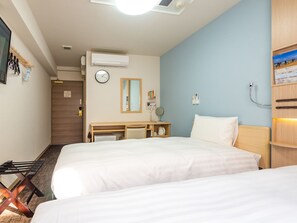 A hotel room with two beds, a desk with a chair, a clock, an air conditioner, and a shelf with a picture. - Toyoko Inn Minami-Machida (Machida)