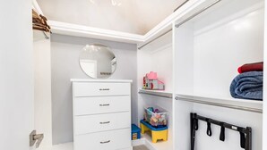 A neatly organized closet with a white dresser, a round mirror, and a hanging rack. - Luxury Aptos Home - Ocean Views & Hot Tub! (Aptos)