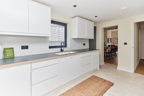 Enjoy cooking in this well-equipped kitchen with an oven, sink, and ample countertop space.