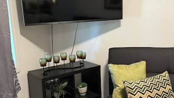 Deluxe Studio Suite | Living area | 50-inch flat-screen TV with cable channels