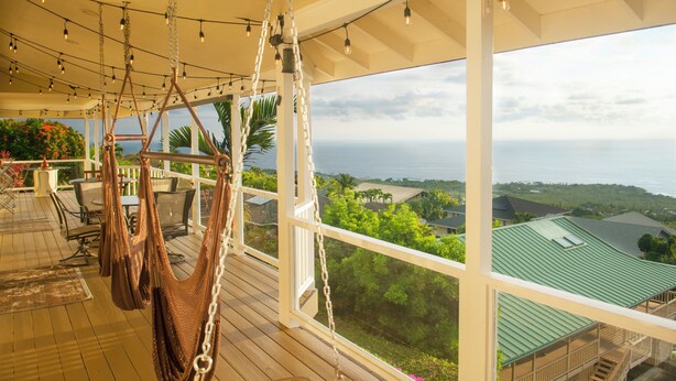 A spacious balcony with a view of the ocean, wooden flooring, and hanging hammocks. - Panoramic view of ocean.  Excellent location. Quiet neighborhood. Sleep 10 (Kailua-Kona)
