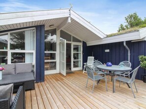 Relax in this serene outdoor space with a comfortable seating area and lush greenery.