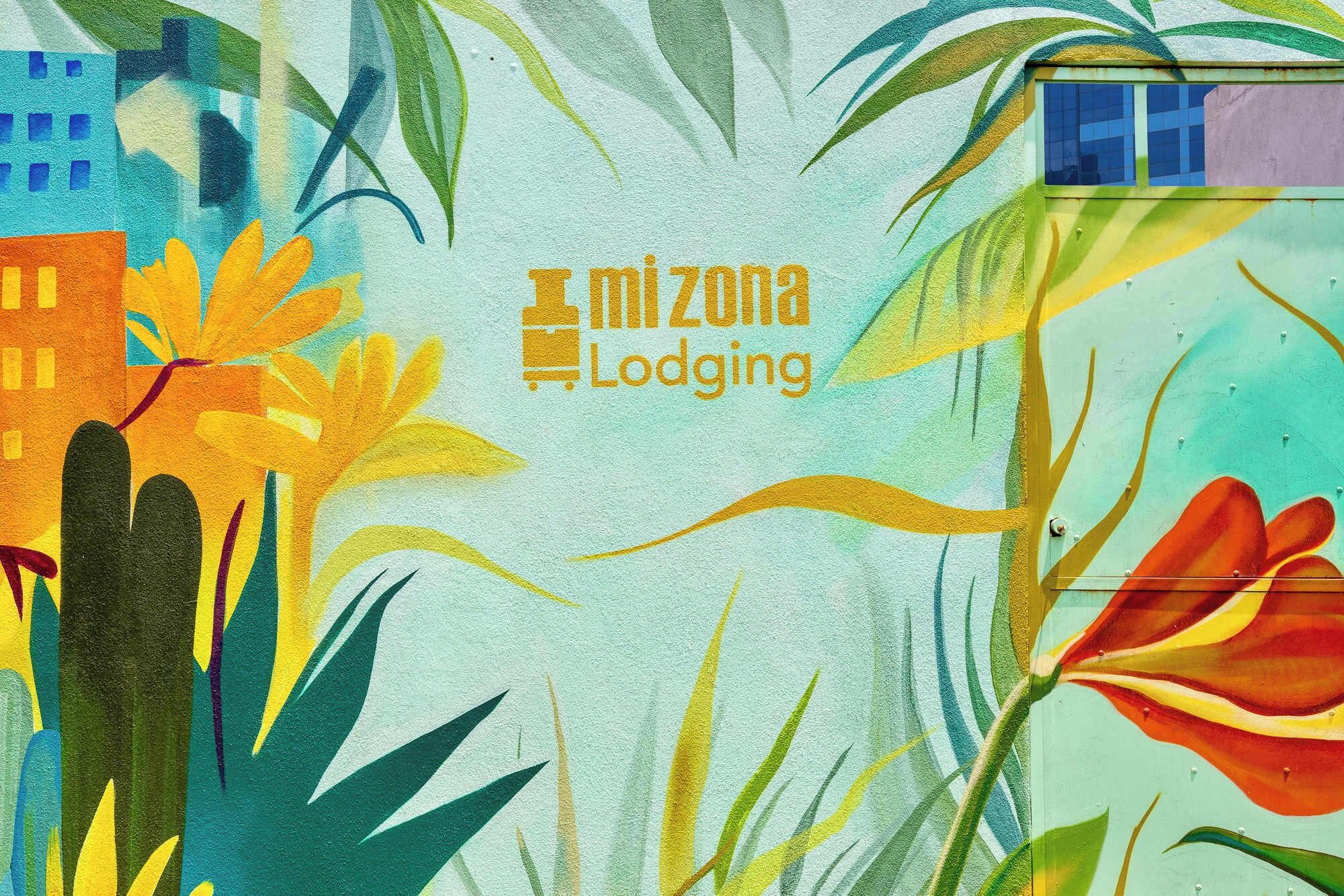 A colorful mural with the text "mi zona Lodging" prominently displayed.