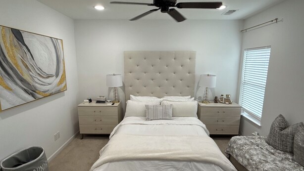 A bedroom with a large bed, two bedside tables, a ceiling fan, a wall-mounted painting, and a window with blinds. - North Lamar hideout  (Oxford)