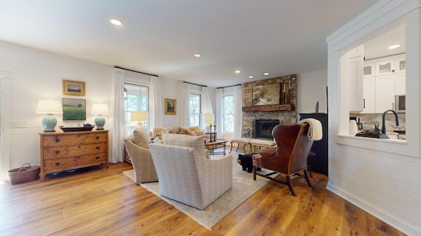 A spacious living room with a fireplace, wooden floors, and a cozy seating area. - Lake Views, a Pool Table, and a Porch Swing. The Perfect Mountain Trip | Lakeview Hideaway (Highlands)