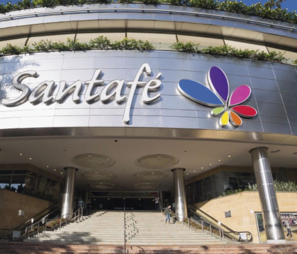 A building with a sign that reads 'Santafé' and a colorful logo.