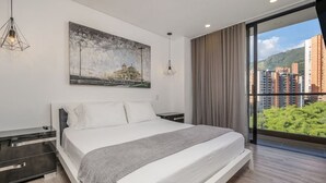 A modern bedroom with a large bed, a cityscape view, and a painting on the wall.