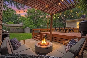 An outdoor patio with a fire pit, seating, and a grill area. - Entertainer - Brookside + Walkable + Firepit (Kansas City)