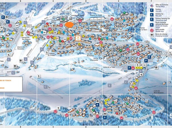 A detailed ski resort map with marked amenities like ski lifts, parking, and restrooms.
