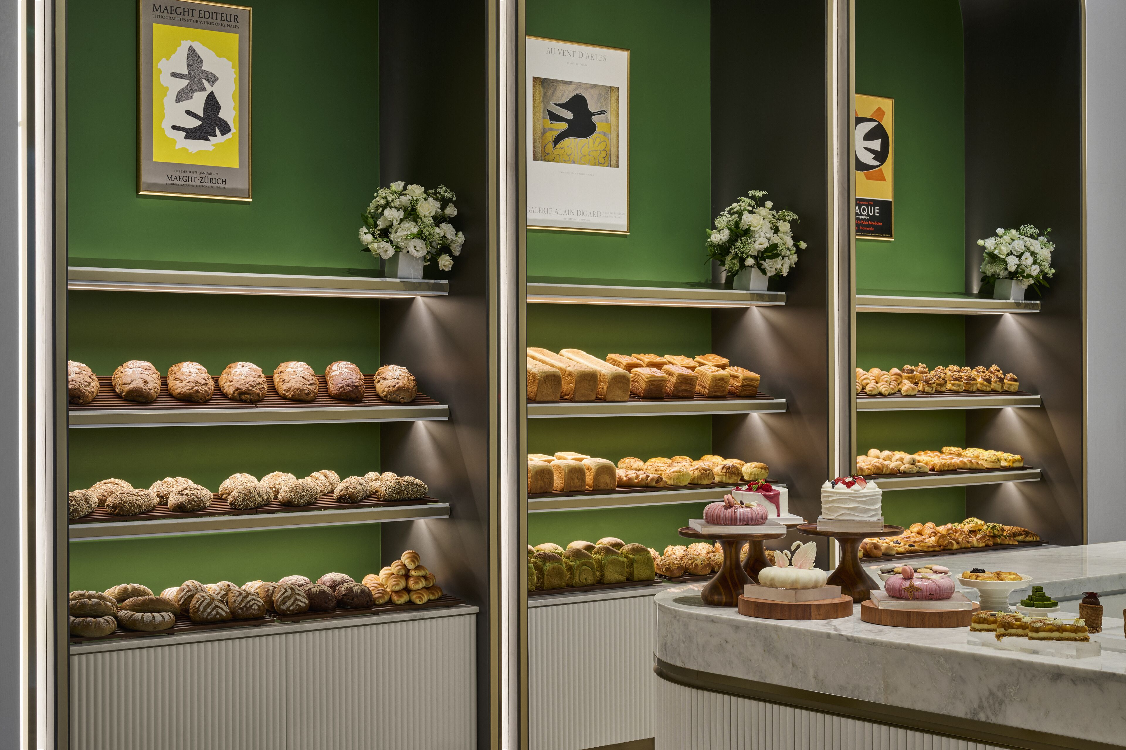 A bakery display with various pastries and cakes.