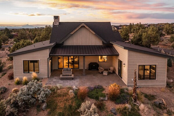 Enjoy a cozy evening by the fire pit in this charming home's spacious seating area.