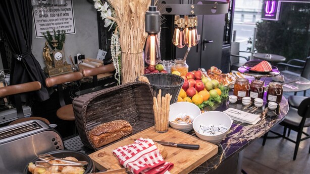 A breakfast buffet with various food items and utensils. - Ultra Ben Yehuda (Tel Aviv)
