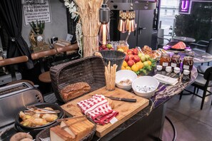 A breakfast buffet with various food items and utensils. - Ultra Ben Yehuda (Tel Aviv)