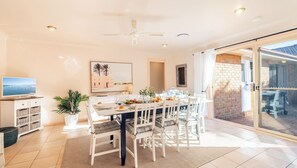 Enjoy meals in this stylish dining area with a large table, comfortable seating, and a beautiful view.