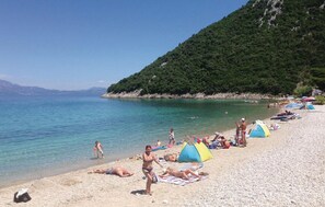 Guests can enjoy the beach with turquoise waters and a sandy shore.