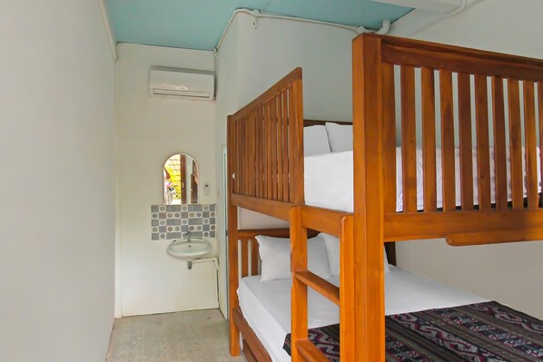 A bunk bed with a wooden headboard, a small bathroom with a sink, and a mirror. - Hotel O Bale Datu Homestay Near Lapangan Bulutangkis By'u Badminton (Senggigi)