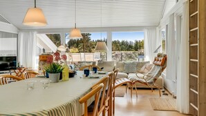 A spacious dining area with a long table, chairs, and pendant lighting. - "Gladis" - 900m from the sea by Interhome (Saltum)