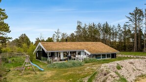 A house with a large porch, a slide, and a swimming pool. - "Gladis" - 900m from the sea by Interhome (Saltum)